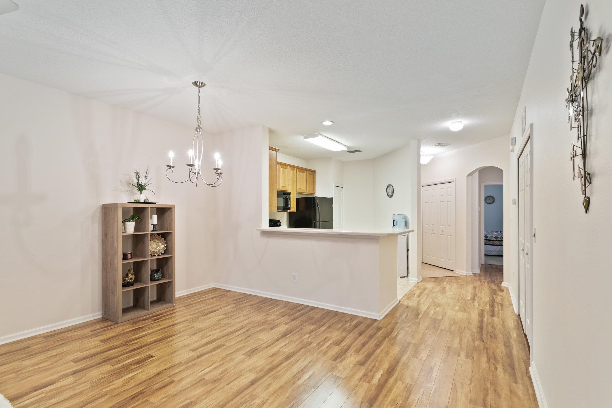 554 Wooded Crossing Circle St. Augustine, FL 32084 - Photo 14 of 43 a view of a kitchen with a fridge and wooden floor