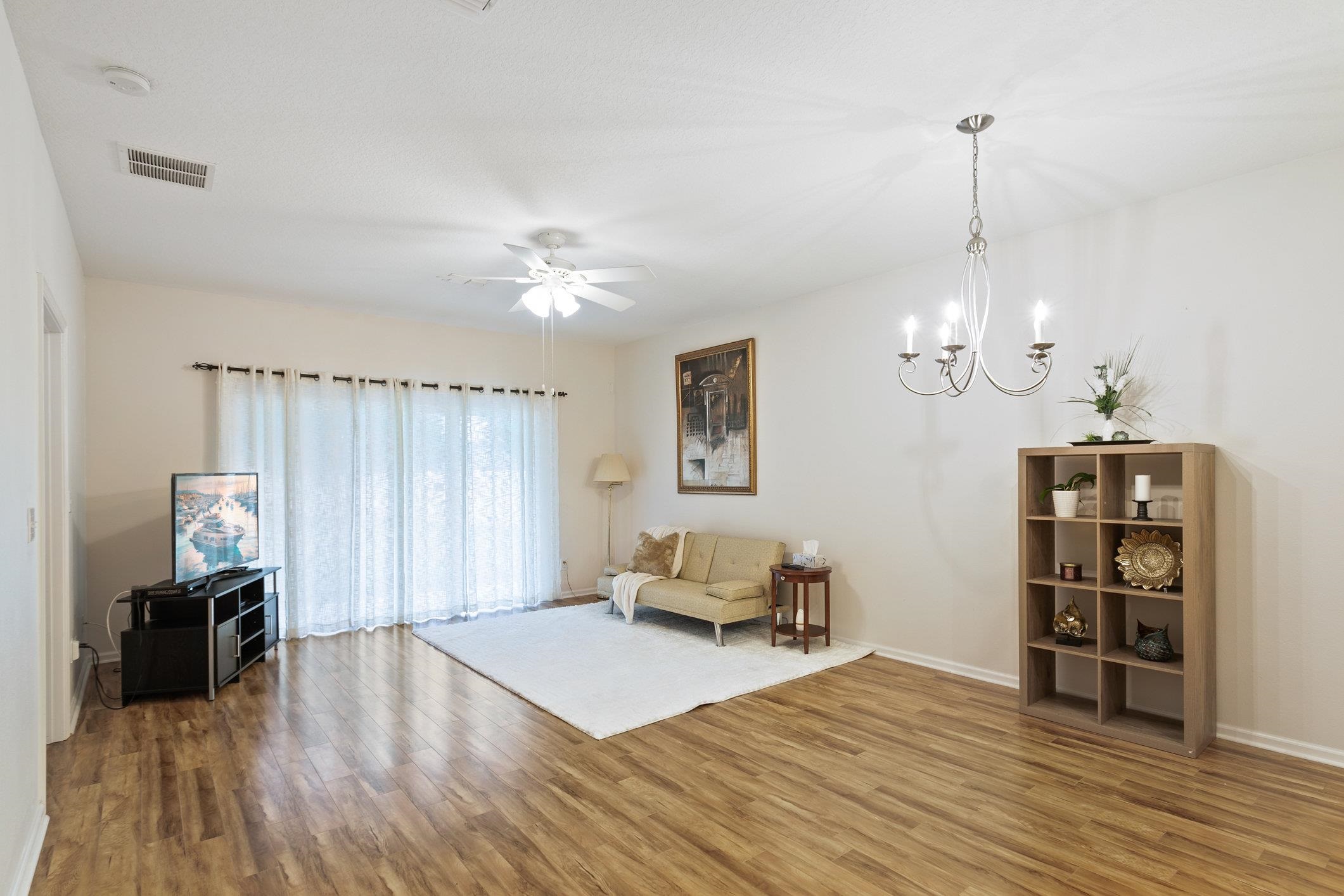 554 Wooded Crossing Circle St. Augustine, FL 32084 - Photo 15 of 43 a living room with furniture and wooden floor