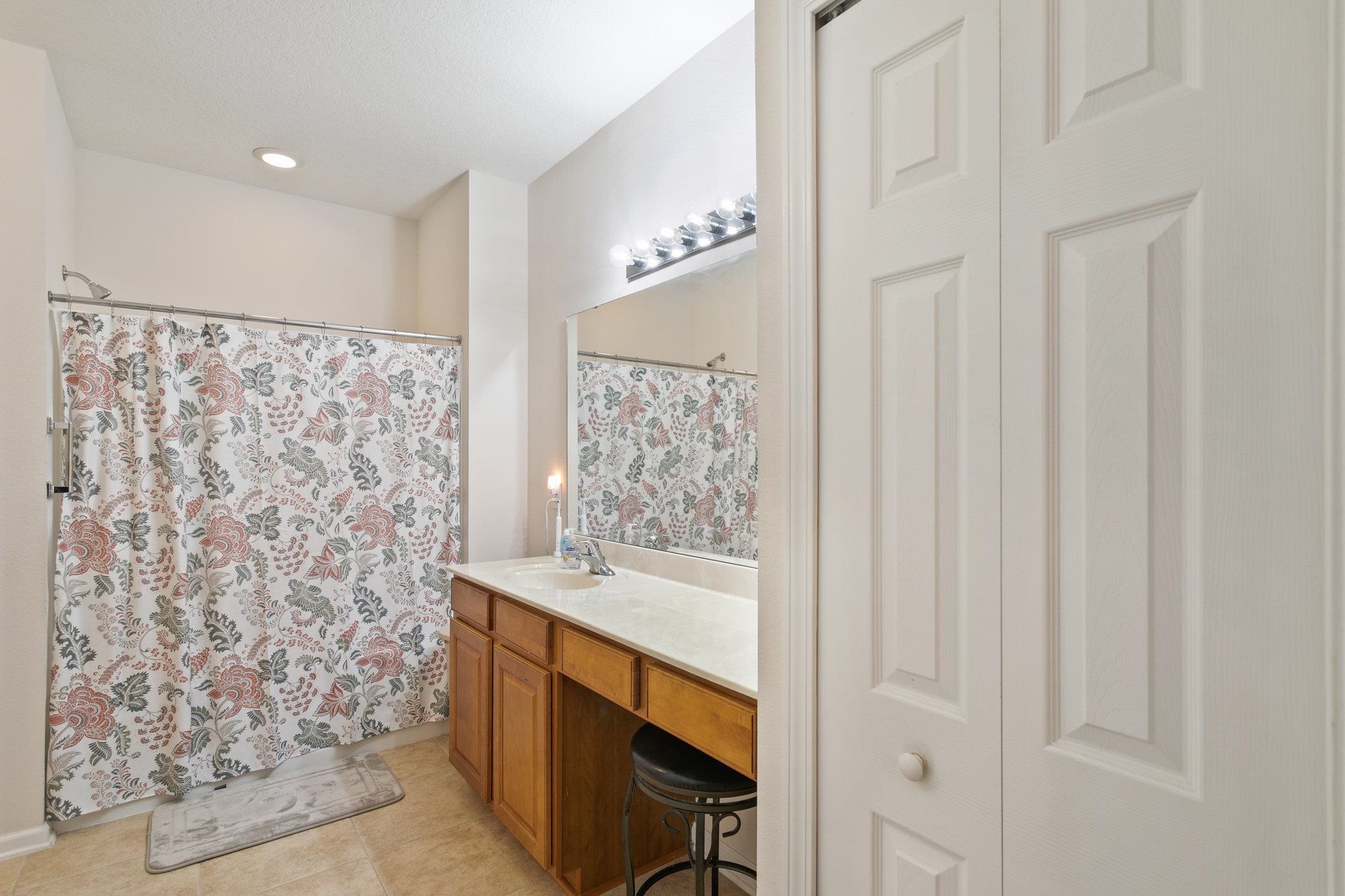554 Wooded Crossing Circle St. Augustine, FL 32084 - Photo 21 of 43 a bathroom with a bathtub and a shower