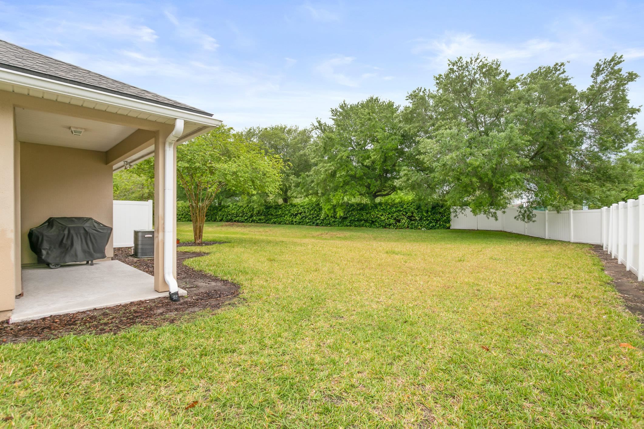 554 Wooded Crossing Circle St. Augustine, FL 32084 - Photo 23 of 43 a view of a swimming pool with an outdoor seating and a garden