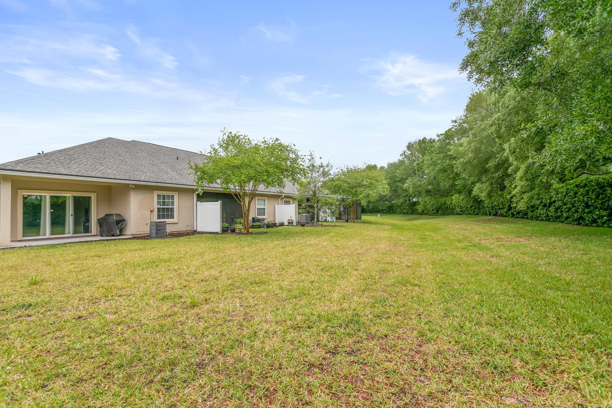 554 Wooded Crossing Circle St. Augustine, FL 32084 - Photo 26 of 43 a front view of a house with a garden