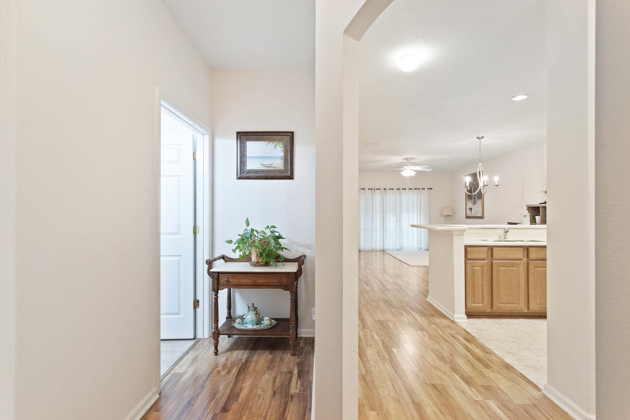 554 Wooded Crossing Circle St. Augustine, FL 32084 - Photo 3 of 43 a living room with kitchen island granite countertop furniture wooden floor and a kitchen view
