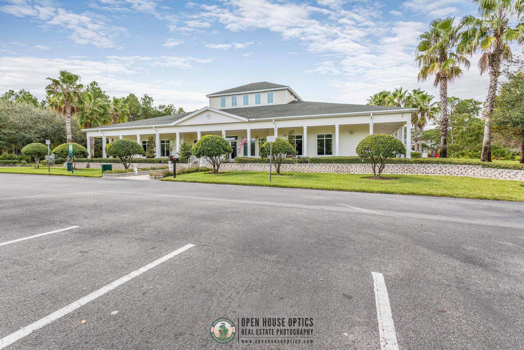 554 Wooded Crossing Circle St. Augustine, FL 32084 - Photo 36 of 43 a front view of a house with a yard and potted plants
