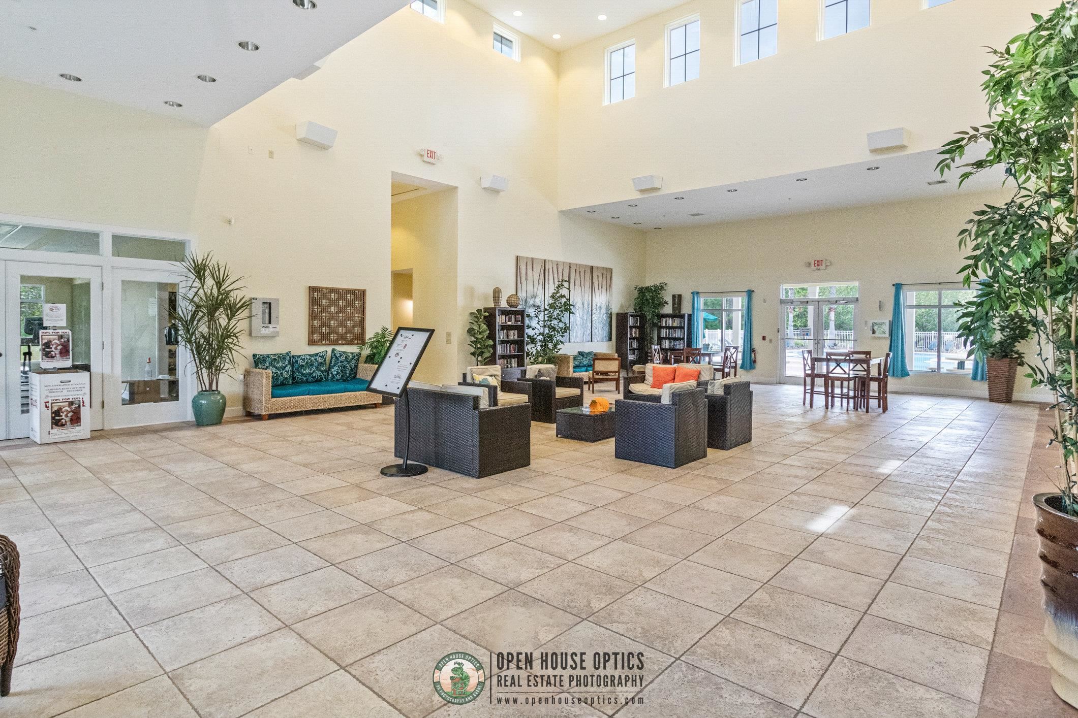 554 Wooded Crossing Circle St. Augustine, FL 32084 - Photo 38 of 43 a room with lots of table and chairs