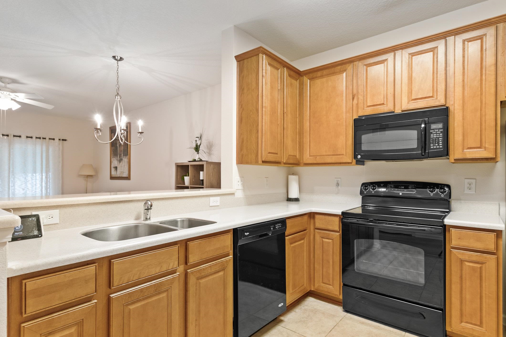 554 Wooded Crossing Circle St. Augustine, FL 32084 - Photo 4 of 43 a kitchen with a stove a sink and a microwave