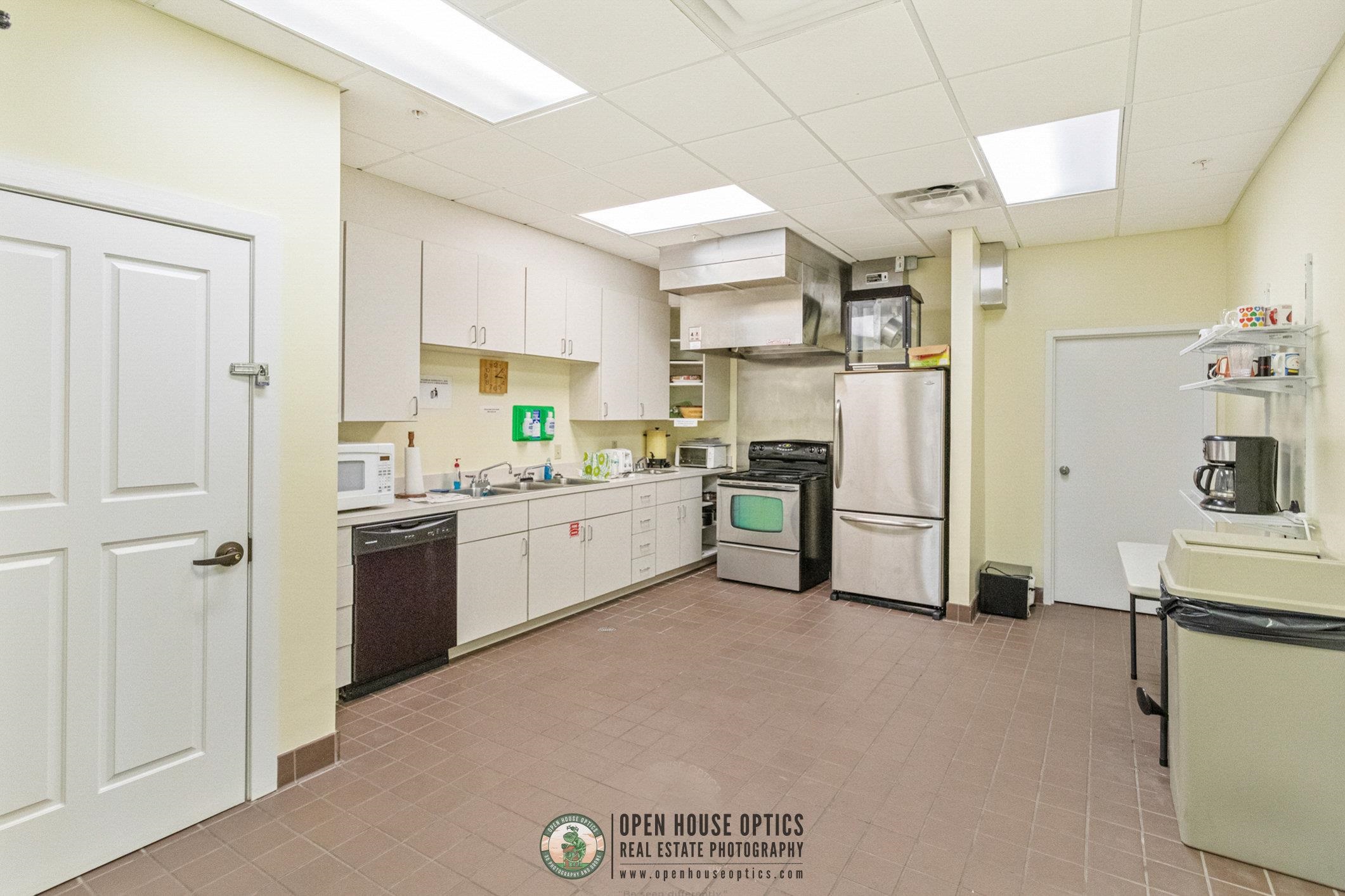 554 Wooded Crossing Circle St. Augustine, FL 32084 - Photo 43 of 43 a kitchen with a refrigerator a sink and cabinets