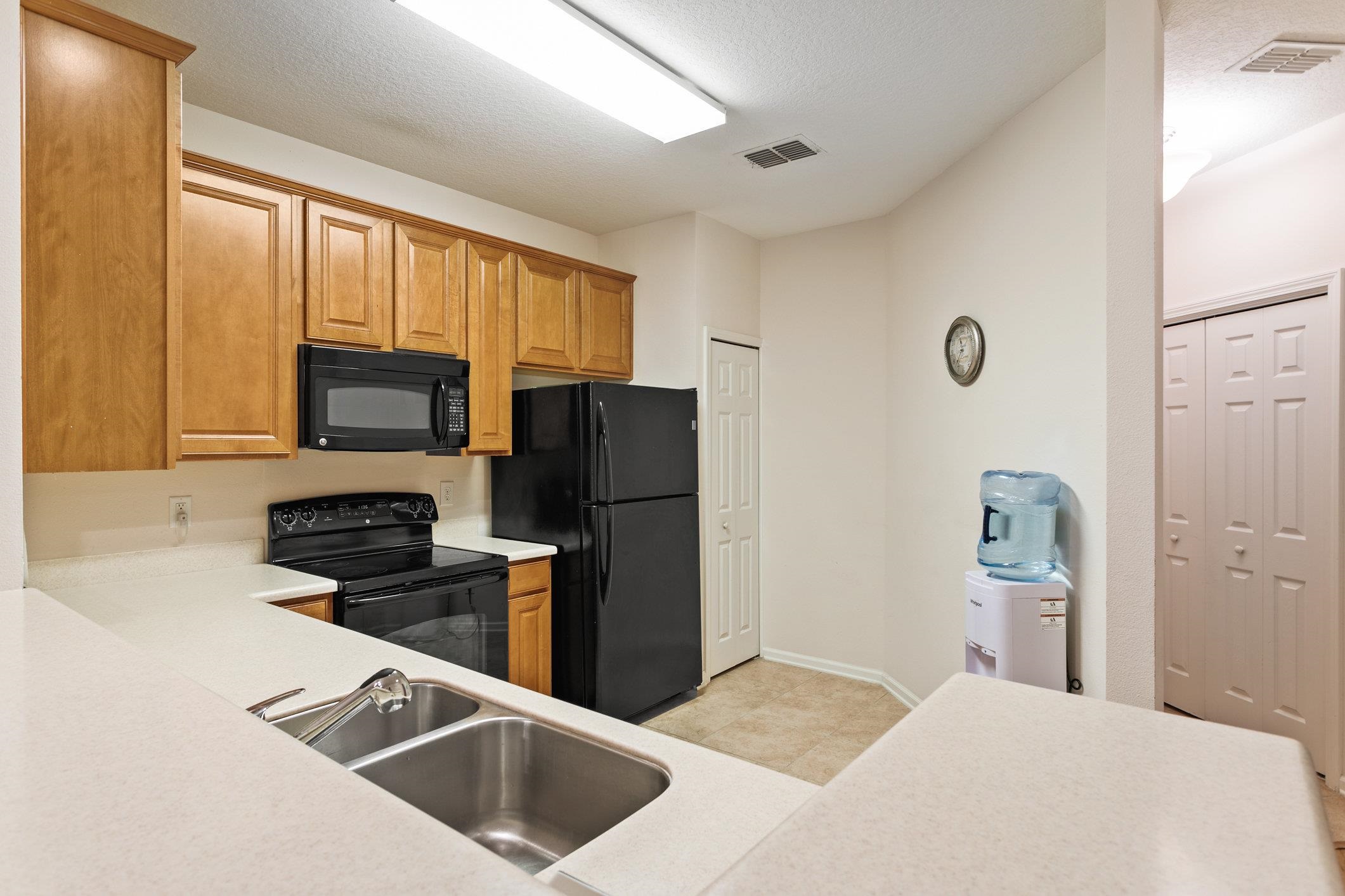 554 Wooded Crossing Circle St. Augustine, FL 32084 - Photo 6 of 43 a kitchen with a refrigerator stove and microwave