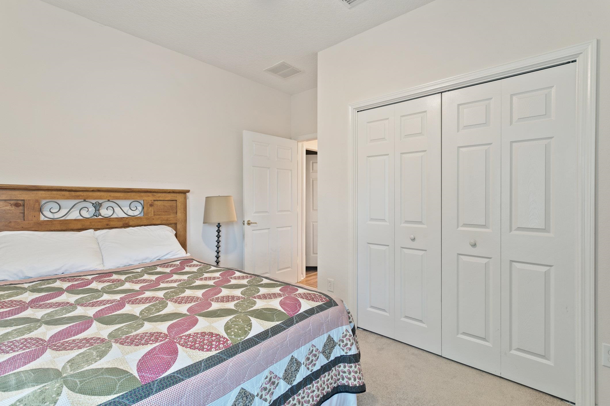 554 Wooded Crossing Circle St. Augustine, FL 32084 - Photo 9 of 43 a bedroom with a bed and a cabinet