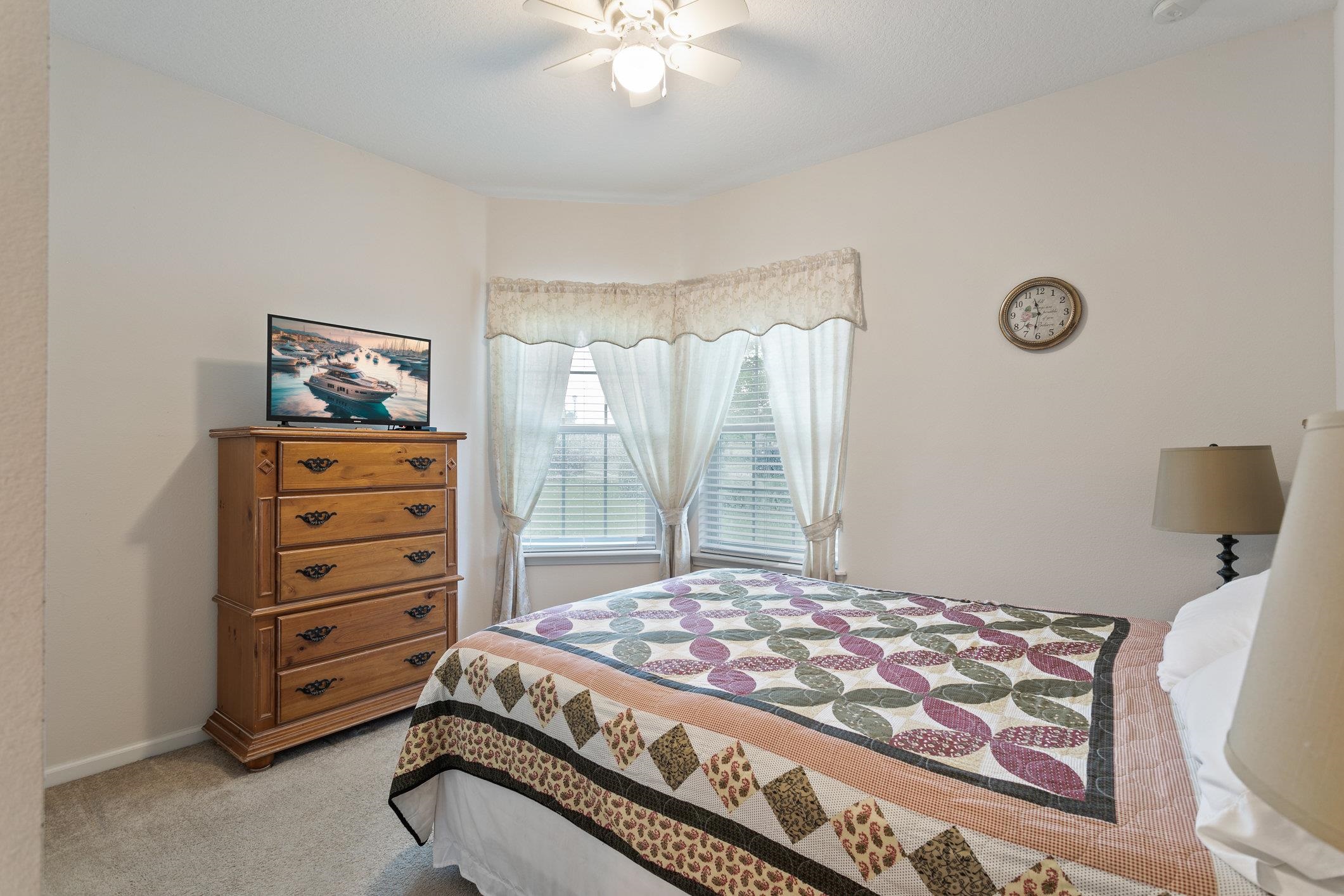 554 Wooded Crossing Circle St. Augustine, FL 32084 - Photo 10 of 43 a bedroom with a bed and a dresser