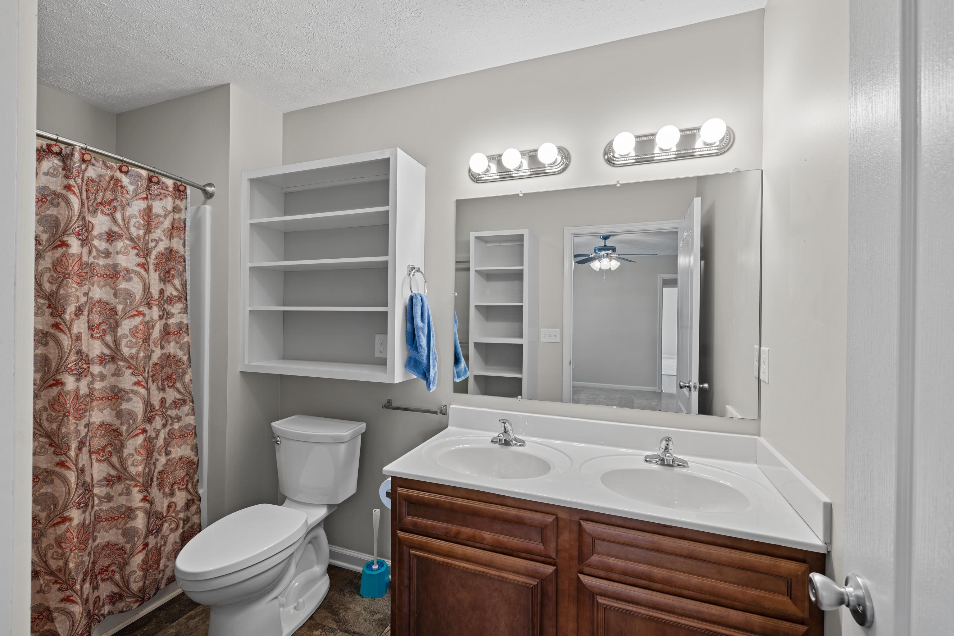 3365 Legion Way Broadway, VA 22815 - Photo 25 of 69 a bathroom with a sink a toilet a mirror and shower curtain
