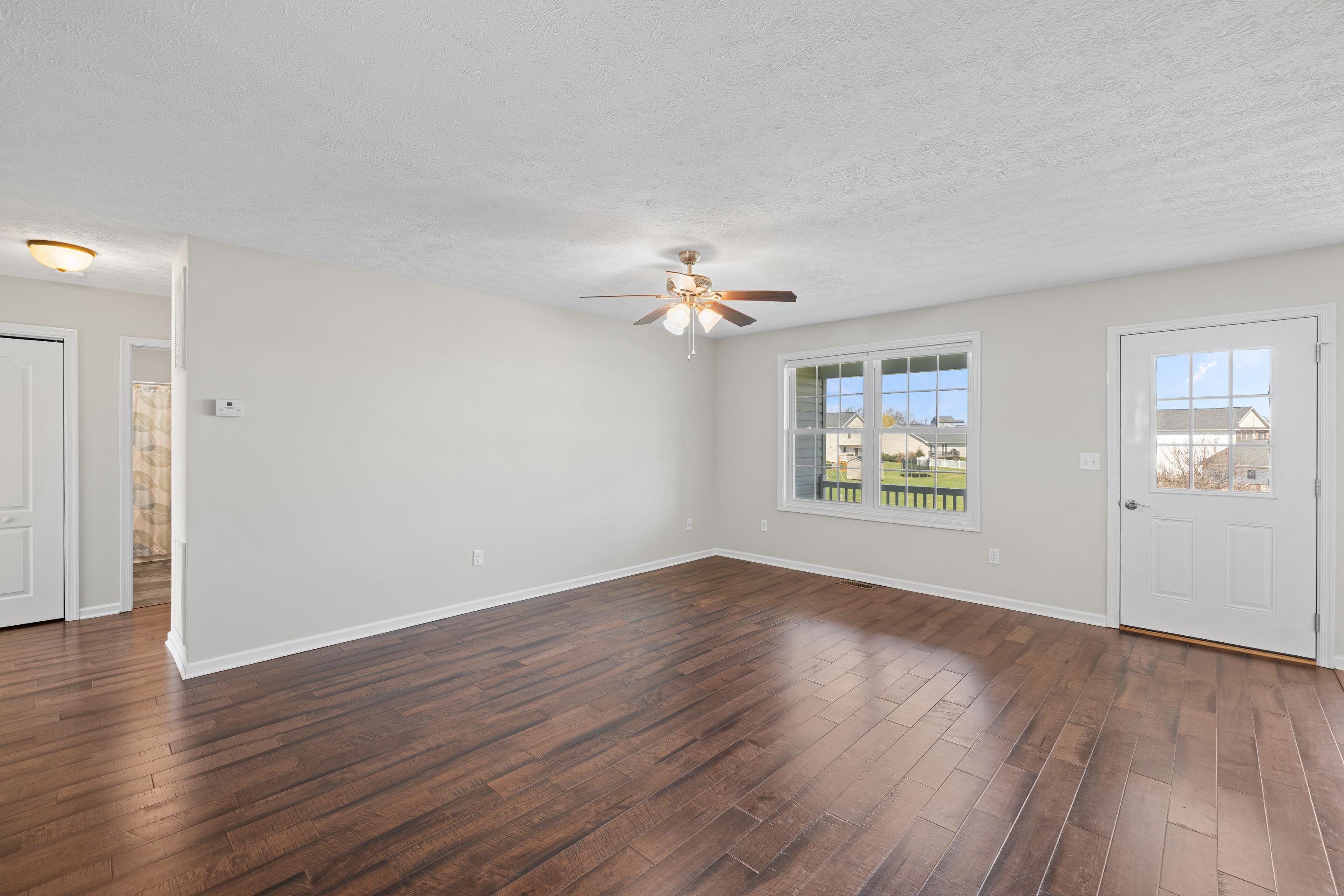 3365 Legion Way Broadway, VA 22815 - Photo 4 of 69 an empty room with wooden floor chandelier fan and windows
