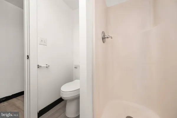 a bathroom with a granite countertop toilet and a shower