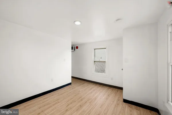 a view of a room with wooden floor and white walls