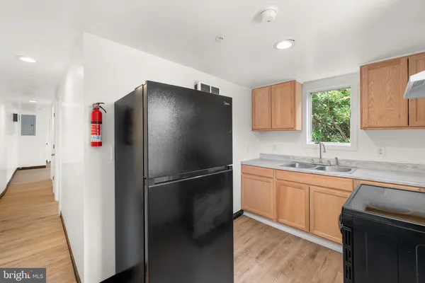 a kitchen with stainless steel appliances a refrigerator and a sink