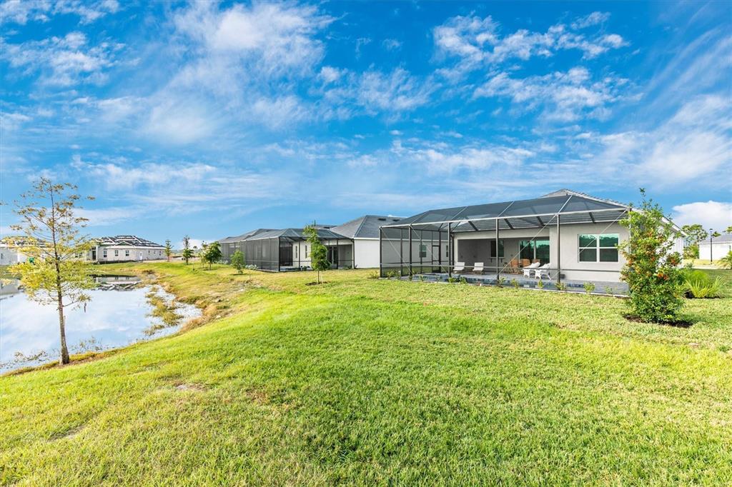12736 Tulum Loop Venice, FL 34293 - Photo 61 of 100 a front view of a house with yard and seating area