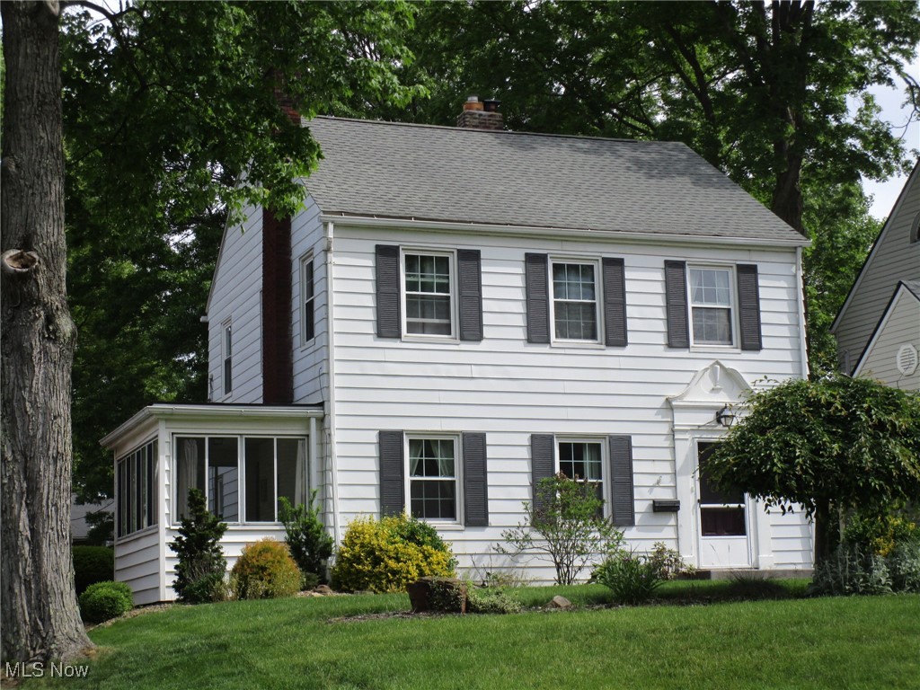 134 Ridgewood Drive Youngstown, OH 44512 - Photo 29 of 29 Colonial home with a sunroom, a chimney, a front lawn, and roof with shingles