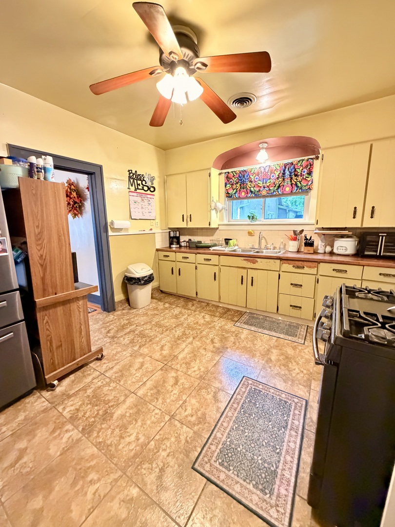 329 West Devlin Street Spring Valley, IL 61362 - Photo 5 of 11 a large kitchen with stainless steel appliances granite countertop a sink and cabinets