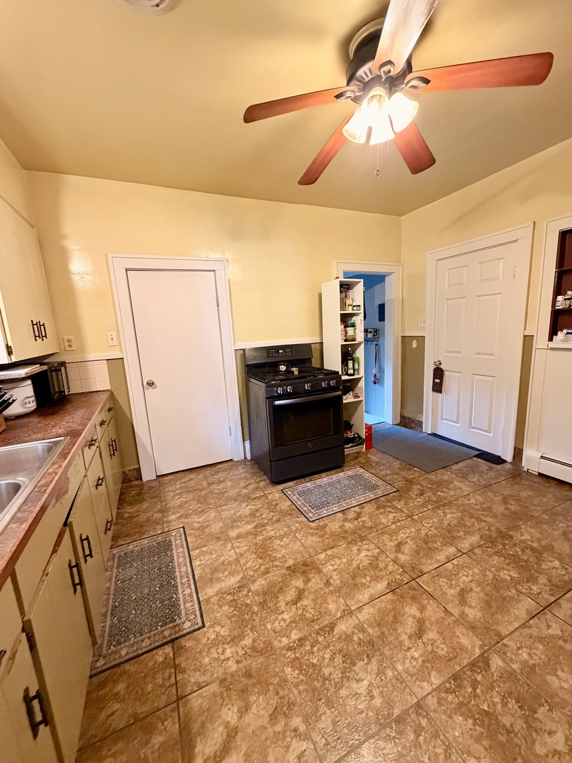 329 West Devlin Street Spring Valley, IL 61362 - Photo 6 of 11 a kitchen with kitchen island a stove a refrigerator and a stove