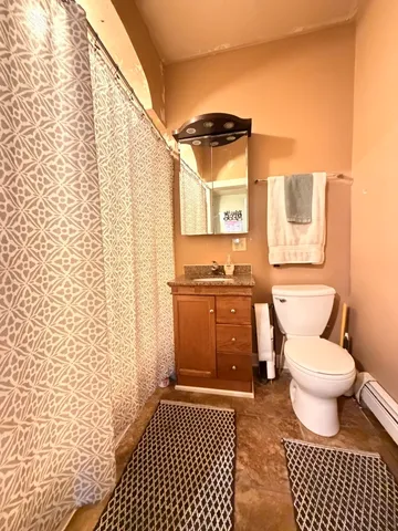 a bathroom with a toilet a sink and a shower