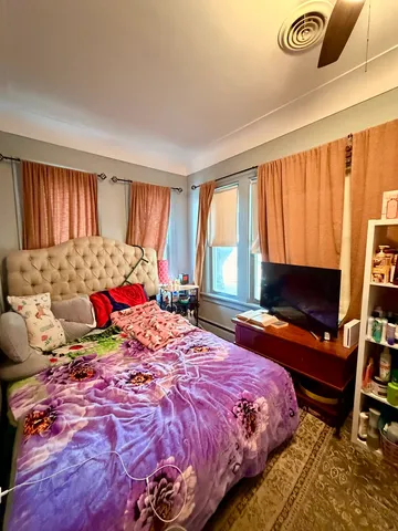 a bedroom with a bed and flat screen tv