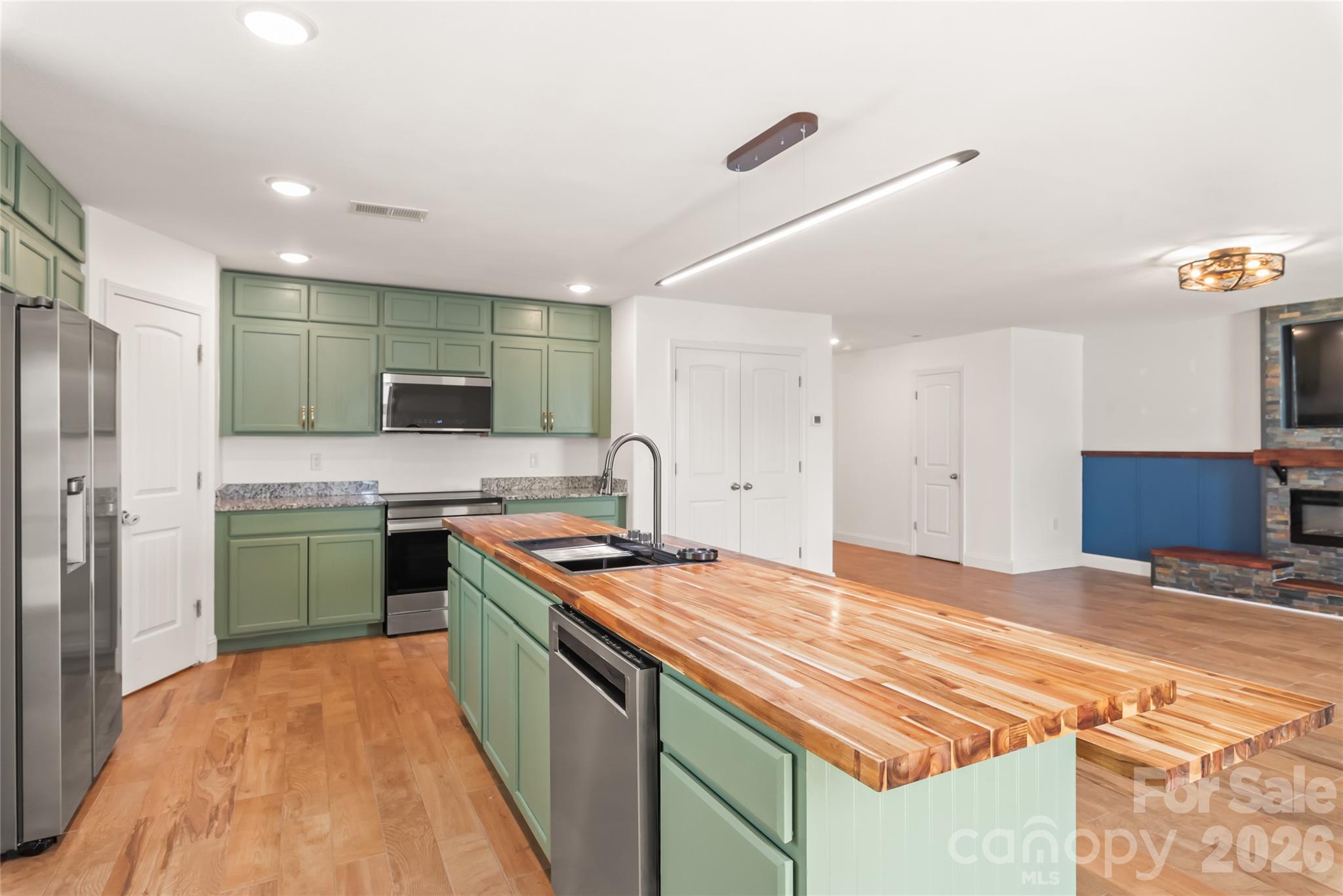 1232 Phifer Road Kings Mountain, NC 28086 - Photo 12 of 36 a kitchen with stainless steel appliances kitchen island a sink stove and refrigerator