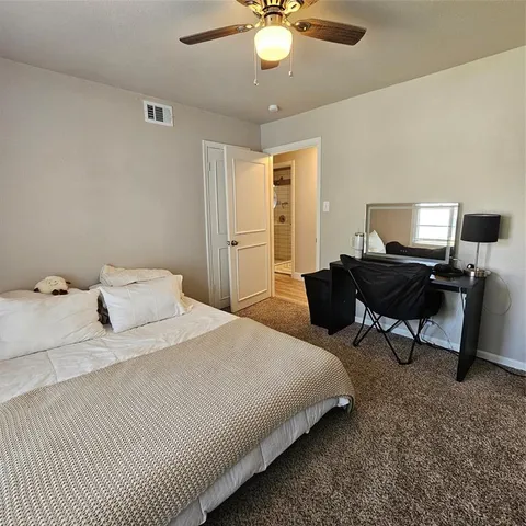a bedroom with bed and a chandelier