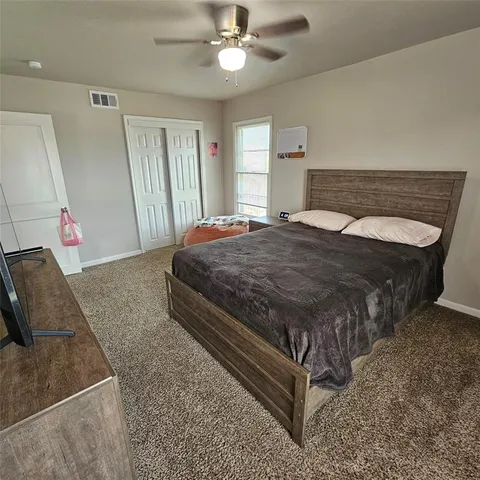 a bedroom with a bed and window