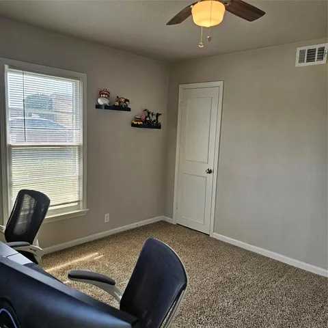 a workspace with a table and chairs