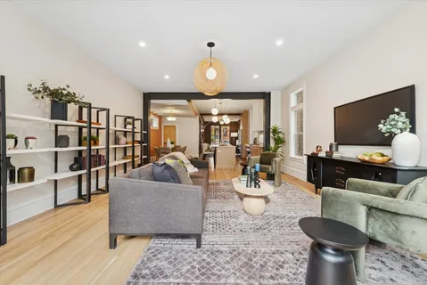 a kitchen with a dining table chairs and white cabinets