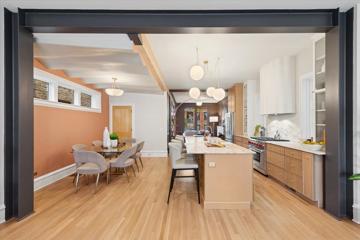 2337 West Belden Avenue Chicago, IL 60647 - Photo 15 of 53 a kitchen with a dining table chairs and white cabinets