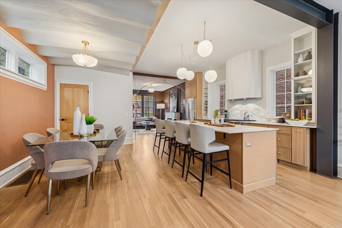 2337 West Belden Avenue Chicago, IL 60647 - Photo 16 of 53 a kitchen with a dining table chairs and white cabinets