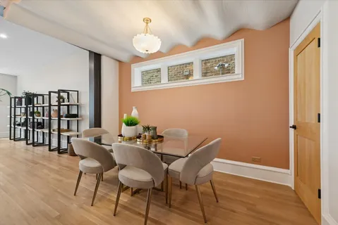a view of a dining room with furniture and wooden floor