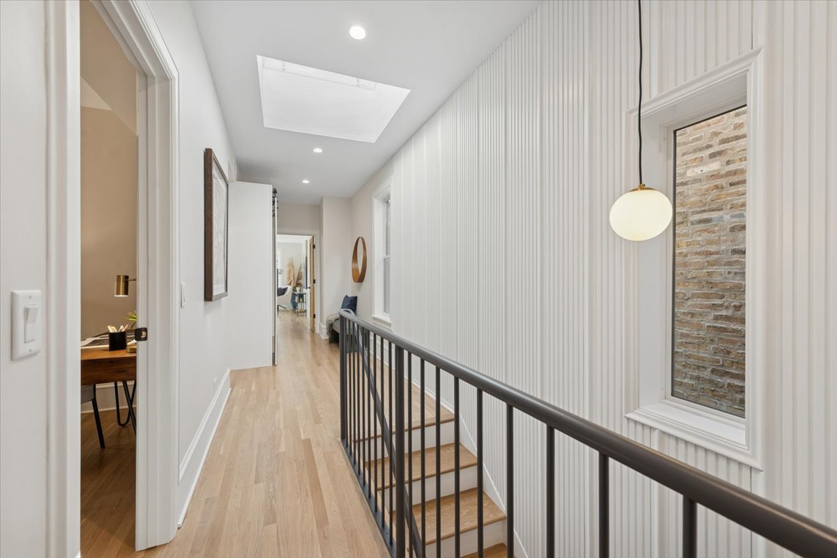 2337 West Belden Avenue Chicago, IL 60647 - Photo 29 of 53 a view of a hallway with wooden floor and staircase