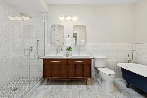 a bathroom with a sink a toilet and mirror