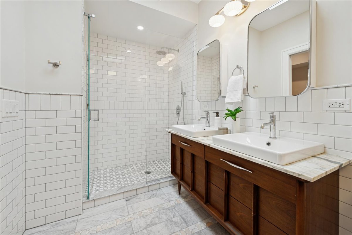 2337 West Belden Avenue Chicago, IL 60647 - Photo 34 of 53 a bathroom with a shower sink and mirror