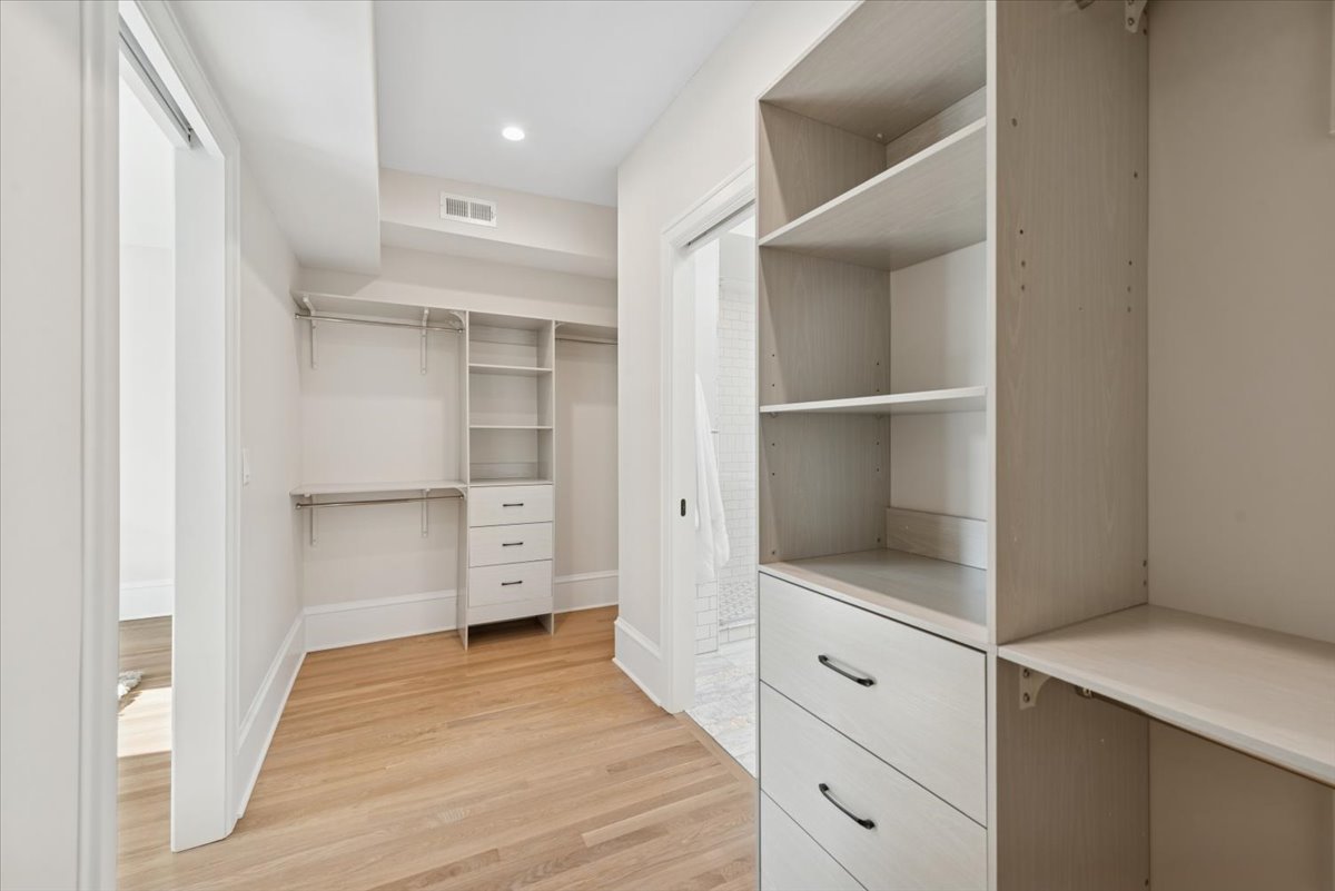 2337 West Belden Avenue Chicago, IL 60647 - Photo 36 of 53 a room with white cabinets and wooden floors