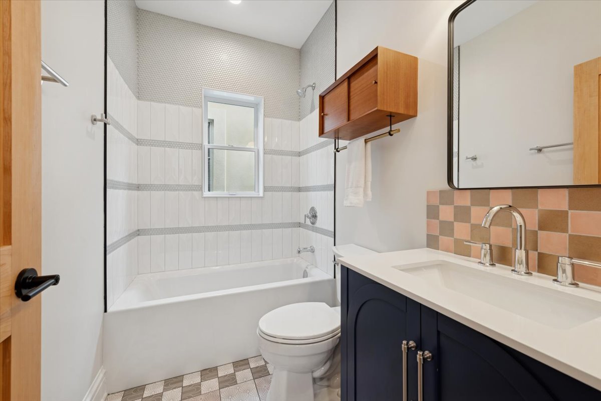 2337 West Belden Avenue Chicago, IL 60647 - Photo 39 of 53 a bathroom with a sink toilet vanity and bathtub
