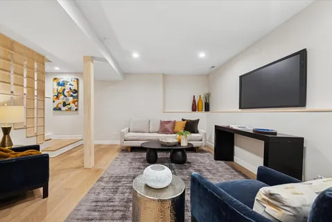 a living room with furniture and a wooden floor
