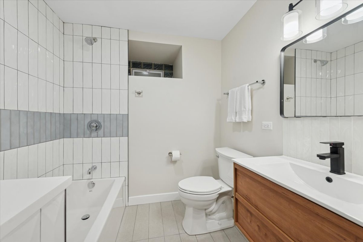 2337 West Belden Avenue Chicago, IL 60647 - Photo 45 of 53 a bathroom with a sink a toilet and shower