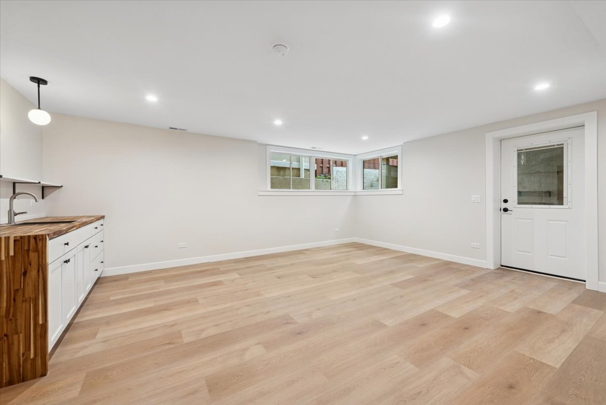 2337 West Belden Avenue Chicago, IL 60647 - Photo 46 of 53 a view of an empty room with window and wooden floor