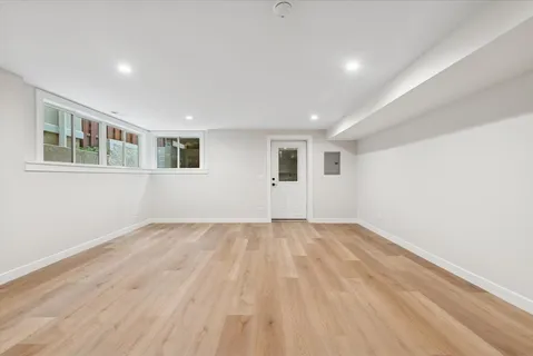 a kitchen with a sink cabinets and wooden floor