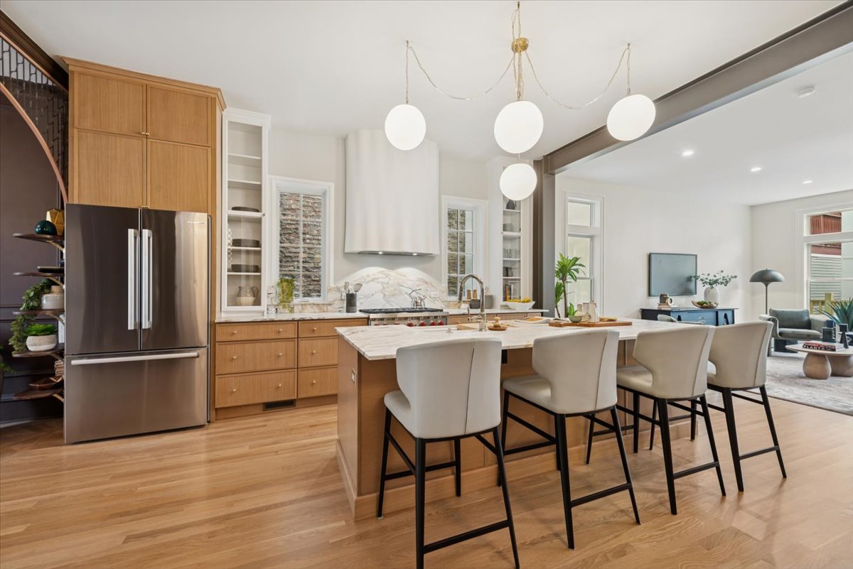 2337 West Belden Avenue Chicago, IL 60647 - Photo 8 of 53 a kitchen with stainless steel appliances granite countertop a sink a stove a refrigerator dining table and chairs