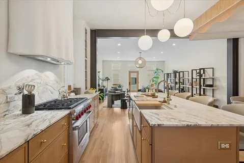 a bed sitting in a kitchen next to a window