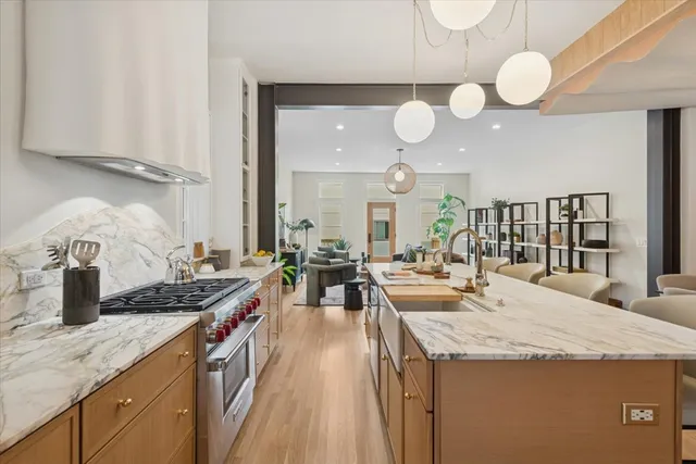 a bed sitting in a kitchen next to a window