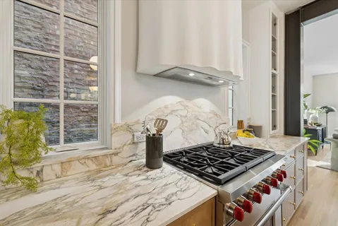 a large kitchen with a stove and a sink