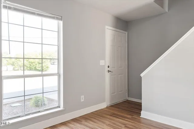 a view of wooden floor and windows in a room