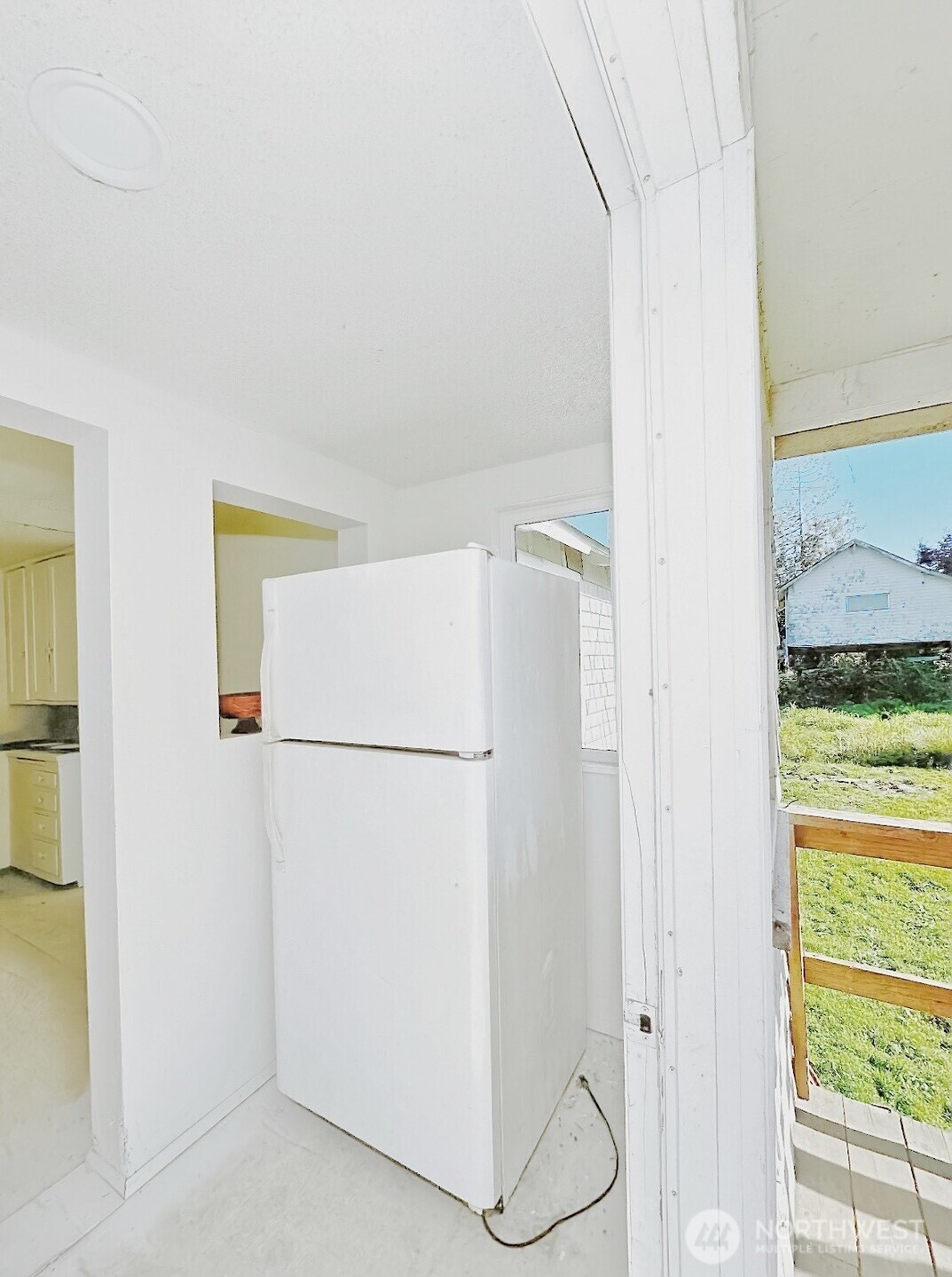 1202 West Perry Street Aberdeen, WA 98520 - Photo 25 of 35 a white refrigerator freezer and a window