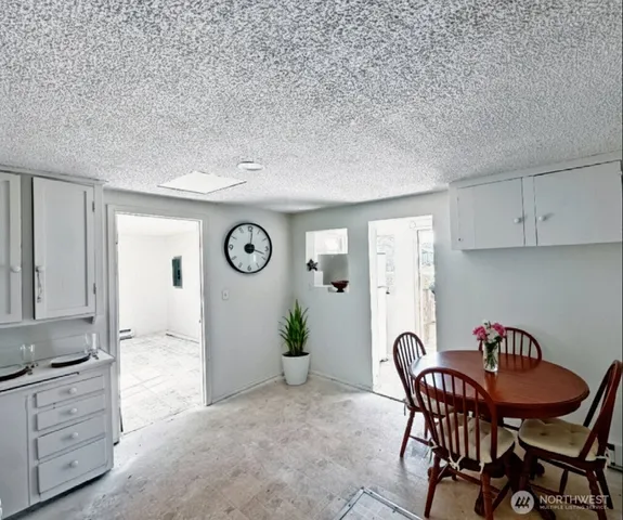 a view of a dining room with furniture and a potted plant