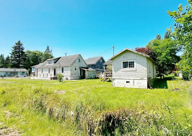 a front view of a house with yard and green space