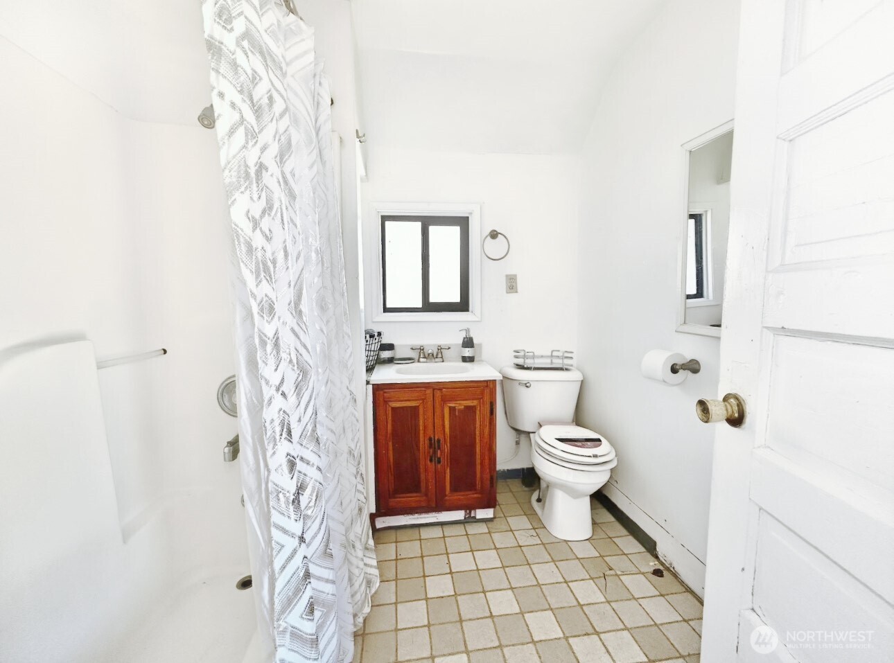1202 West Perry Street Aberdeen, WA 98520 - Photo 8 of 35 a bathroom with a granite countertop toilet a sink and a shower